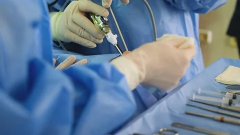 Surgeons performing endoscopic sinus surgery in operating room Stock Footage 316399978