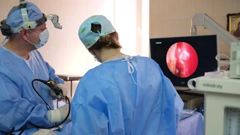 Surgeons performing endoscopic surgery in operating room Stock Footage 316399153