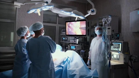 Surgeons performing laparoscopic surgery in operating room Stock Footage 306166942