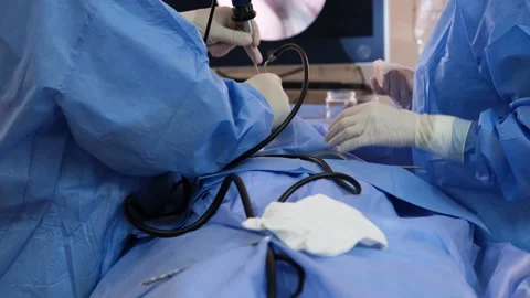 Surgeons performing laparoscopic surgery using specialized instruments Stock Footage 316397797