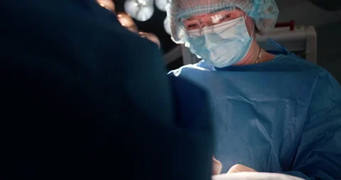 Surgeons performing modern operation in operating room Stock Footage 302715938