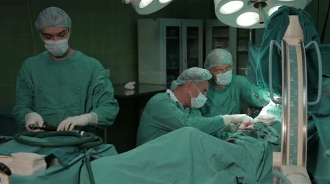 Surgeons performing operation in hospital operating room, end of operations. Stock Footage 50955532
