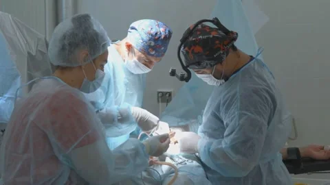 Surgeons Performing Operation in Hospital Operating Room with Nurse Assistanc 스톡 동영상 331774129