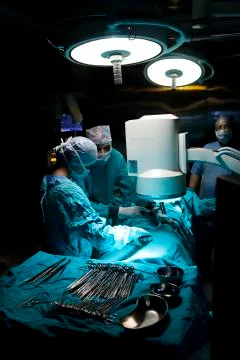 Surgeons performing an operation Stock Photos
