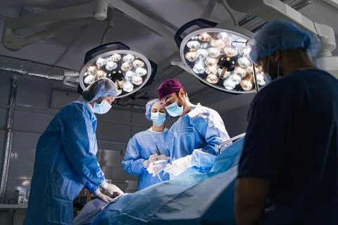Surgeons Performing Operation Stock Photos
