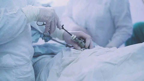 Surgeons performing surgery in operating Theater Stock Footage