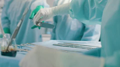 Surgeons prepare instruments in operating room Stock-Footage 280111708