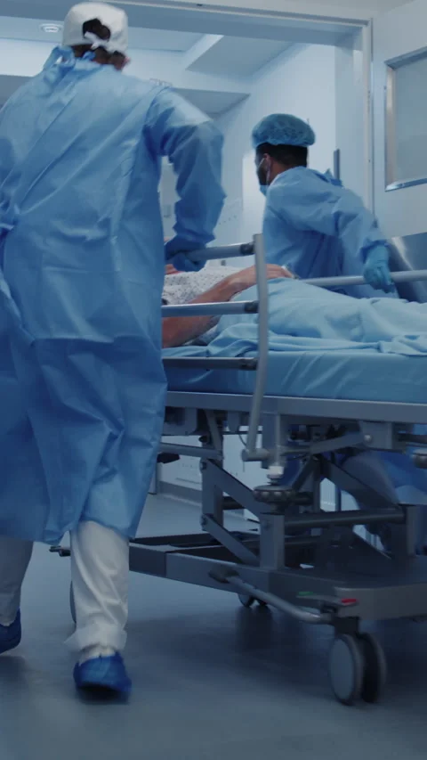 Surgeons push stretcher with lying elderly man Stock Footage 275226636