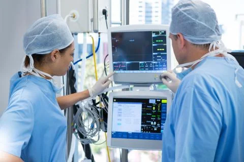 Surgeons reading computer screen Stock Photos