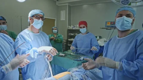 Surgeons rejoice at the completion of the operation Stock Footage 173419057