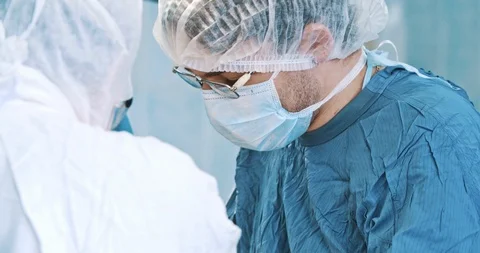 Surgeons team during operation with surgical laparoscopy instruments. Medicine Stock Footage 121104200