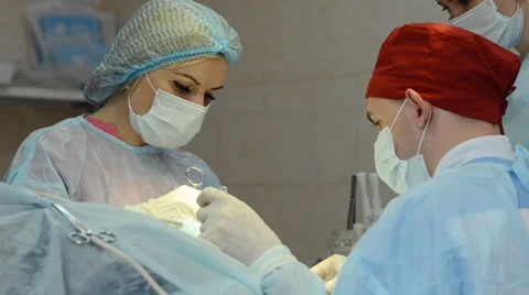 Surgeons team operates with the patient Stock Footage 64543924