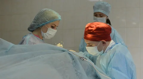 Surgeons team operates with the patient Stock Footage 64543928