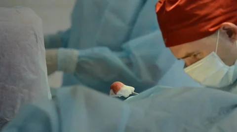 Surgeons team operates with the patient Stock Footage 64543953
