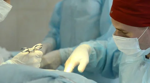 Surgeons team operates with the patient Stock Footage 64543982
