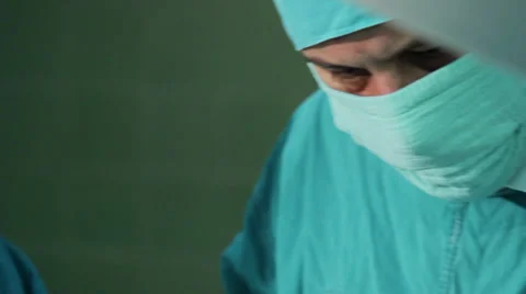 Surgeons team performing operation in hospital operating room, close up face. Vídeo Stock 34968034