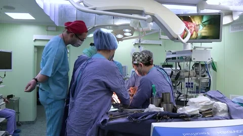Surgeons team performing an operation in a hospital operating room. Editorial Stock Footage 147596302