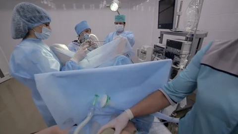 Surgeons team performing surgical operation,operating room. A team of Stock Footage 82851728