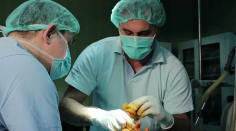 Surgeons team preparing patient arm for operation on operating table.Tilt down. Stock Footage 34918677