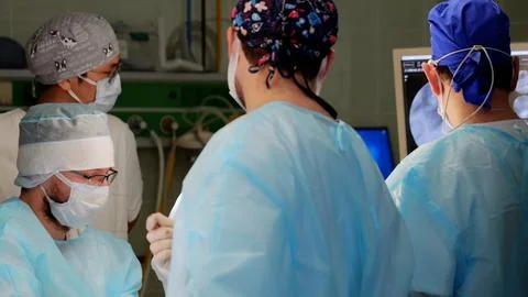 Surgeons team work meticulously in operating room microsurgery save patient life Stock Photos