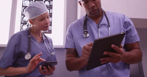 Surgeons using smartphone and tablet Stock Footage 59039285
