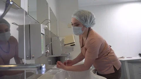Surgeons washing his hands in a surgical washroom Stock Footage
