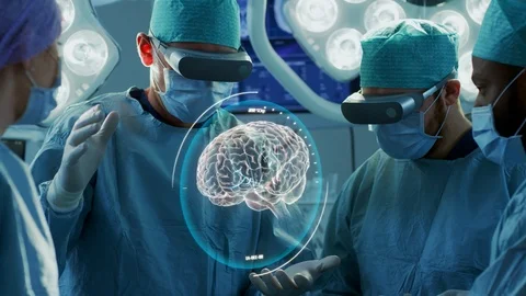 Surgeons Wearing Augmented Reality Glasses Perform Brain Surgery. Stock Footage