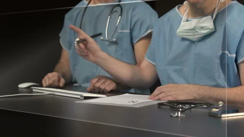  Surgeons working with big screen Stock Footage 210228640