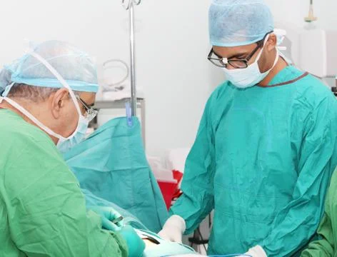 Surgeons working in operation room Stock Photos