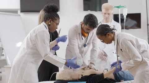 Surgery: doctors performing operation on dummy. First aid course Video stock 270176118