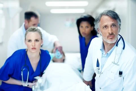 Surgery, emergency and help with doctors in hospital for running, medical crisis Stock Photos