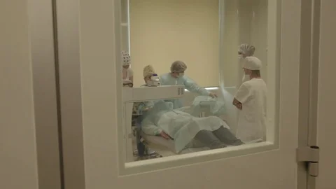 Surgery of eye behind the door Stock Footage 81323085