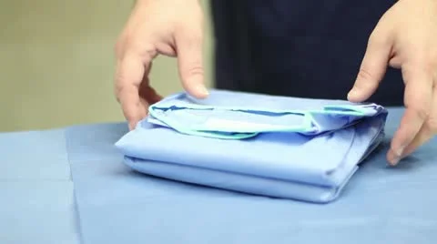 Surgery Prep - Surgeon Picks Up Gown Видео 12519581