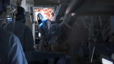 Surgery team and robot perform complex operation. High-tech medical equipment Stock Footage 102218462