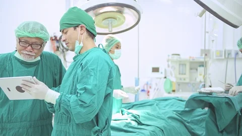 Surgery team looking at operation result in tablet. Stock Footage 92348198