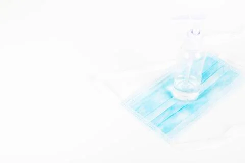 Surgey mask with alcohol gel on withe background Stock Photos