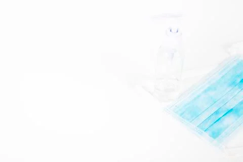 Surgey mask with alcohol gel on withe background Stock Photos