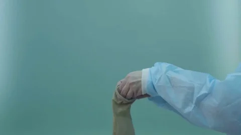 Surgical assistant putting on protective gloves Stock-Footage 75663668