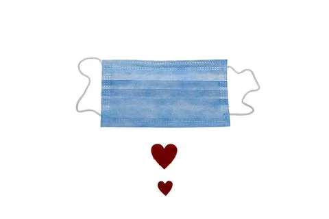 Surgical face mask and red heart shape. covid-19 concept. isolated on white. Stock Photos
