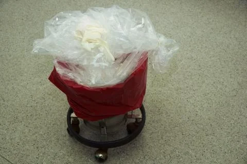 Surgical gloves on garbage bin Stock Photos