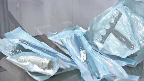 Surgical instruments and tools including scalpels, forceps and tweezers arranged Stock Footage 81646474