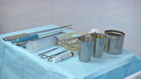 Surgical instruments and tools including scalpels, forceps and tweezers arranged Stock Footage 83203523