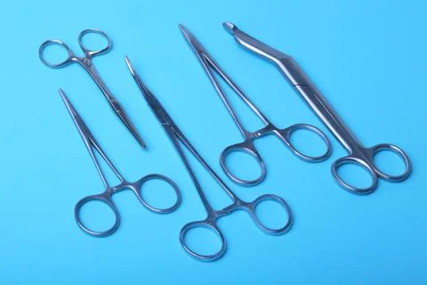 Surgical instruments and tools including scalpels, forceps and tweezers arranged Stock Photos
