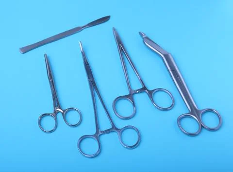 Surgical instruments and tools including scalpels, forceps and tweezers arranged Stock Photos