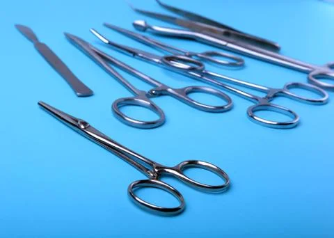 Surgical instruments and tools including scalpels, forceps and tweezers arranged Stock Photos