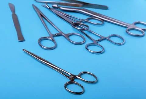 Surgical instruments and tools including scalpels, forceps and tweezers arranged Stock Photos