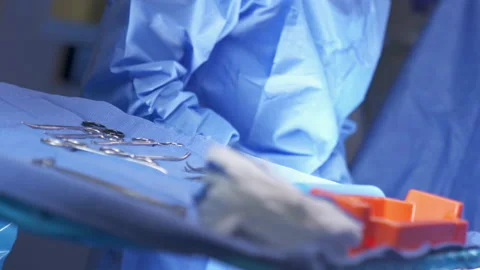 Surgical Instruments in Foreground Tray with Surgeon Stock Footage 171141040