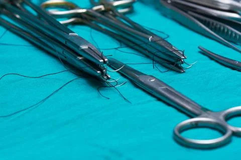Surgical instruments on the green operating table Stock Photos