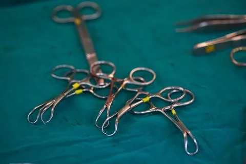 Surgical instruments on the green table in operating room Stock Photos