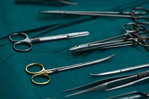 Surgical instruments on green table Stock Photos